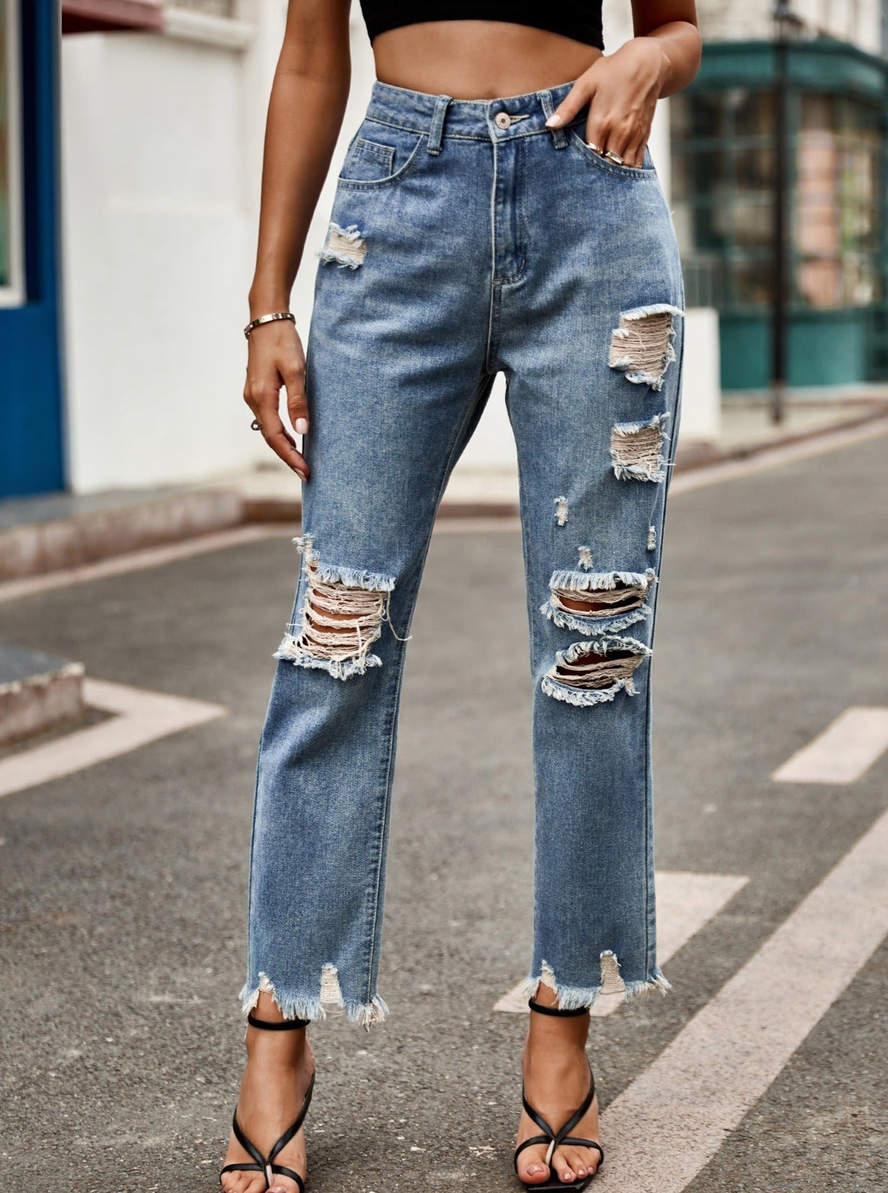 Gescheurde flare-denimjeans met hoge taille en knopen 